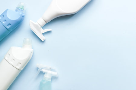 Flat lay cleaning products on a blue background. Cleaning tool mockup. toilet cleanerの写真素材