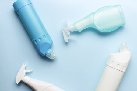 Flat lay different cleaning products on a blue background. clean bottle mockupの写真素材