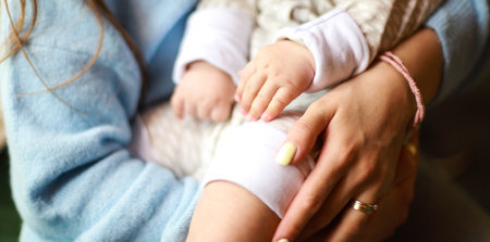 Banner Mom holds the baby in her arms. Mom and baby in a restaurant.の写真素材