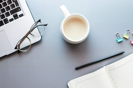 Mockup diary. Flat lay freelancer desktop. businessman morning. A cup of coffee on the desktop with a laptop. back to school. Distant workの写真素材
