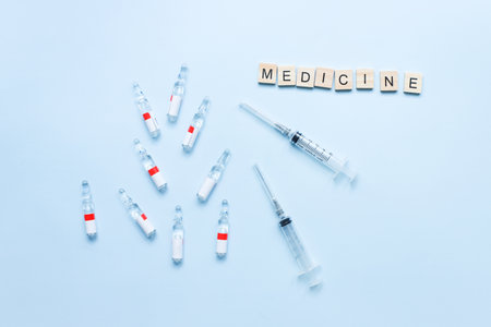 Flat lay medicine. Word medicine from letters. Syringes and ampoules. vaccination. treatmentの写真素材