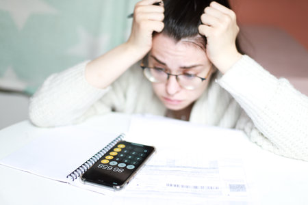 The woman has a lot of debts for bills. credit counting. Difficult financial situationの写真素材
