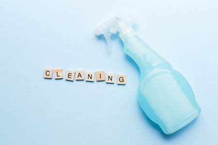 The word cleaning made of wooden letters. Flat lay cleaning spray. Mockup sprayの写真素材