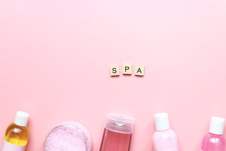 Flat lay spa on a pink background. Spa word from wooden letters. Cosmetics on a pink backgroundの写真素材