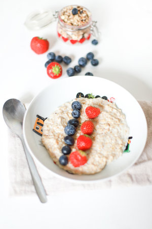 Oatmeal for breakfast for kids. Proper nutrition. Porridge with berriesの写真素材