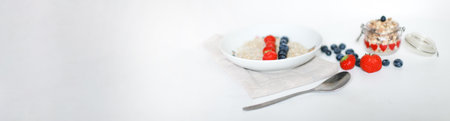 Banner Oatmeal with berries for breakfast. A plate of oatmeal on a towelの写真素材