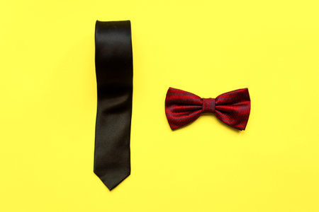 Flat lay bow tie and necktie on a yellow background. happy fathers day. Male attributesの写真素材