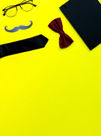 Banner Flat lay fathers day on yellow background. Mockup diary. Tie, glasses, mustacheの写真素材
