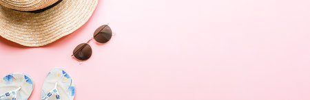 Banner Flat lay summer on a pink background. summer accessories. Hat, slippers, glassesの写真素材