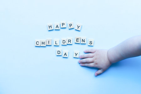 Flat lay happy children's day on blue background. children's hand. Children Protection Dayの写真素材