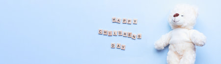 Banner Flat lay Children is Day. white baby bear. Children is day made of wooden lettersの写真素材