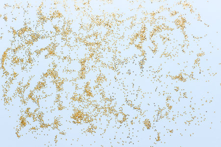 Stars on a blue background. Golden sparkles on a blue background. Christmas sparklesの写真素材