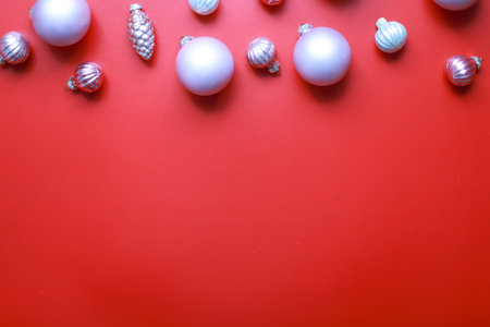 Flat lay Christmas toys on a red background. Pink toys for the Christmas treeの写真素材
