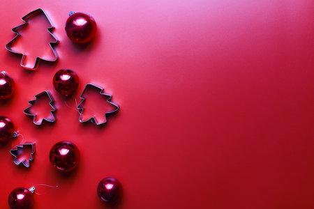 Flatly Christmas toys for the Christmas tree. Molds for gingerbread. Christmas decorations on a red backgroundの写真素材