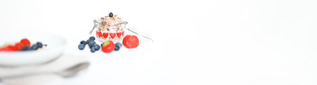 Banner Granola in glass. Proper nutrition. Muesli with berriesの写真素材