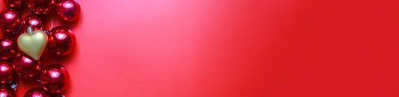Banner Christmas toys on a red background. Golden heart toy. Christmas decorationsの写真素材