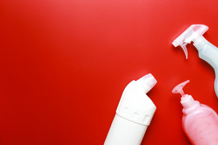 Flat lay mockup of cleaning products on a red background. Cleanliness, tidying upの写真素材