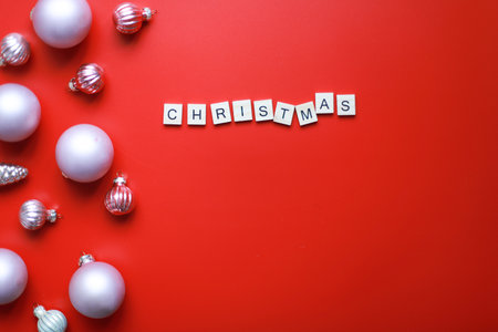 Flat lay inscription Christmas on a red background. Christmas decorations. christmas cardの写真素材