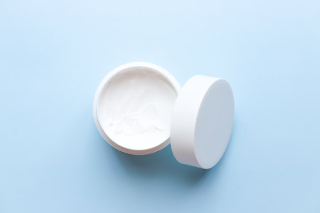 Flat lay face cream on blue background. Spa, beauty. personal care.の写真素材