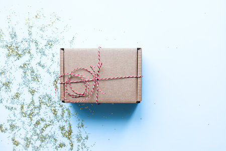 Flat lay craft box on a blue background. gift box mockupの写真素材