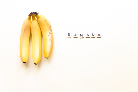 flat bananas. The word bananas from wooden letters. Veganism, fruitarianismの写真素材