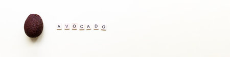 Banner Flatly avocado. Word avocado from wooden letters. Veganism, fruitarianismの写真素材