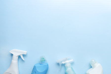 Flat lay housekeeping on a blue background. Cleaning products top view. Cleaning bottle mockupsの写真素材
