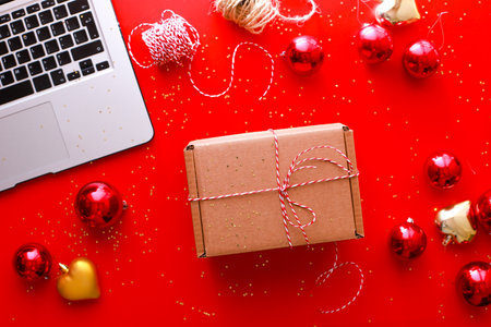 Flat lay gift wrapping on red background. craft gift. Online shopping for Christmasの写真素材