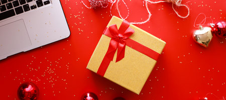 Banner Flatly christmas on red background. gift wrapping. Buying gifts onlineの写真素材