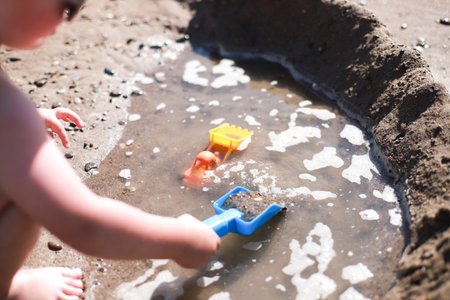 A child plays on the beach. Toys on the beach in the sandの写真素材