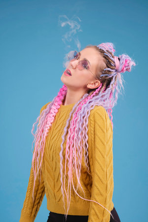 Young woman, creative person, smoking electronic cigarette, blowing smoke