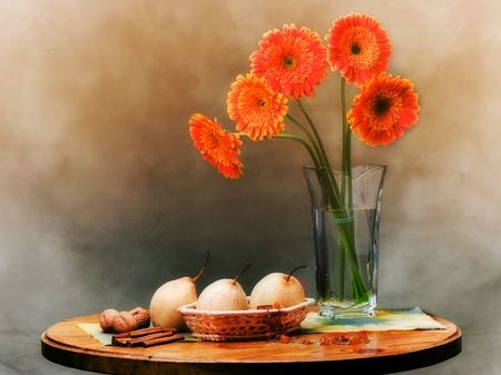 Elegant sill life with orange flowers, peers, nuts and amberの写真素材