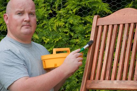 male outside garden painting deck chairの写真素材