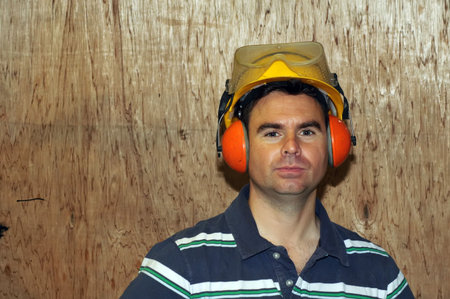picture of male wearing safety hat, glasses and ear protection
