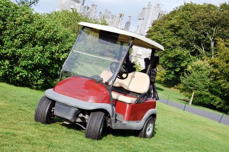 golf cart on luxury golf course by castleの写真素材