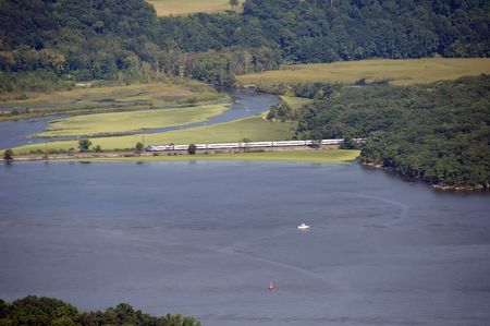 valley river in usa with a train passing through over a bridgeの写真素材