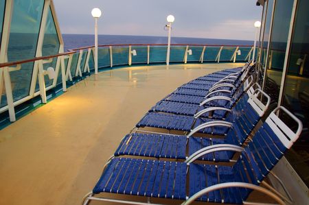 photo lounge chairs in a row on a ocean cruise shipの写真素材