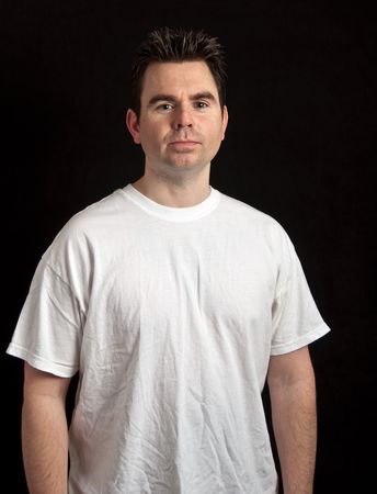 portrait of male in his 30's on black backgroundの写真素材