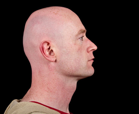 photo close up picture of a male head from side on black