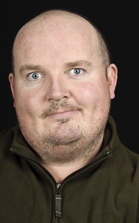 photo male portrait of man smiling on blackの写真素材