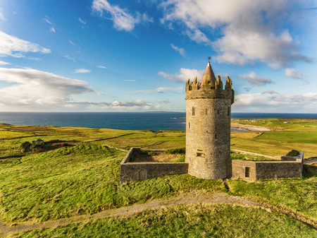 Aerial Famous Irish Tourist Attraction In Doolin, County Clare, Ireland. Doonagore Castle is a round 16th-century tower Castle. Aran Islands and along The Wild Atlantic Way.のeditorial素材