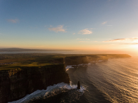 Aerial Ireland countryside tourist attraction in County Clare. The Cliffs of Moher sunset and castle Ireland. Epic Irish Landscape along the wild atlantic way. Beautiful scenic irish nature.の写真素材