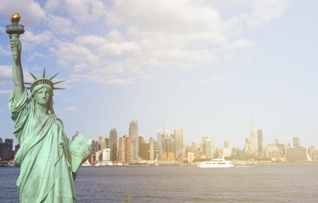 new york city skyline sunshine ray. famous new york city cityscape and skyline landmark over the hudson river. with new york statue of liberty.の写真素材
