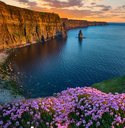beatiful sunset from the cliffs of moher in county clare, ireland. the cliffs of moher is one of irelands top tourism attractions aloing the wild atlantic wayの写真素材