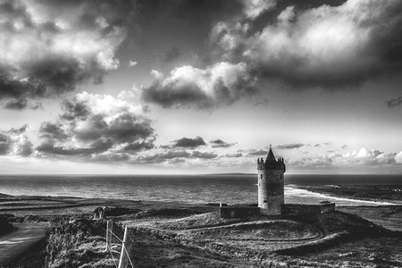 epic black and white Doolin Castle in County Clare, Ireland. scenic irish countryside along the wild atlantic wayのeditorial素材