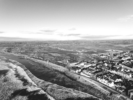 Aerial view of Ireland's top surfing town and beach in Ireland. Lahinch Lehinch town and beach in county clare. Beautiful scenic rural countryside in ireland.の写真素材