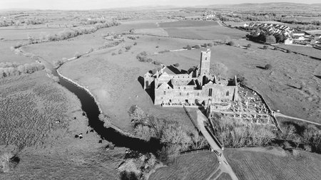 black and white photograph of an old irish ruined castle abbey. quin abbey in county clare irelandの写真素材