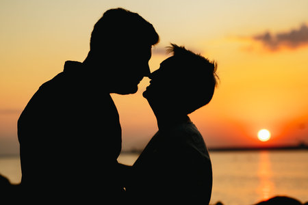 silhouette of loving couple on sunset on beach. high quality photoの写真素材