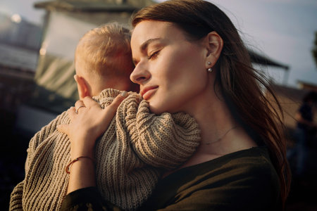 beautiful caucasian young woman couple holding baby son at the quay of city Saint-Petersburg,...