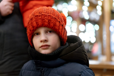 cute caucasian boy in red hat on christmas marked. high quality photo